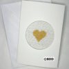 A white card with a gold heart in the middle.