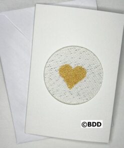 A white card with a gold heart in the middle.