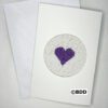 A card with a purple heart on it.