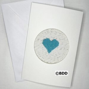 A white card with a blue heart in the middle of it.