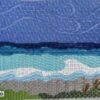 Here's an alt tag for the image: `Needlepoint beach scene, blue sky and waves`