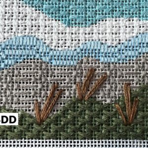 A close up of the stitch pattern on a cross-stitched picture.