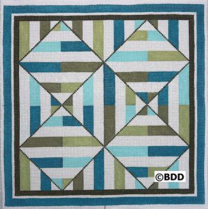 A quilt with blue, green and white squares.