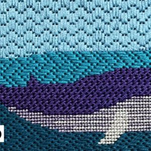 Needlepoint whale in ocean scene.