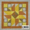 A square quilt block with a yellow star on it.