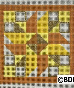 A square quilt block with a yellow star on it.