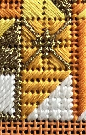 A close up of the thread work on a piece of art.