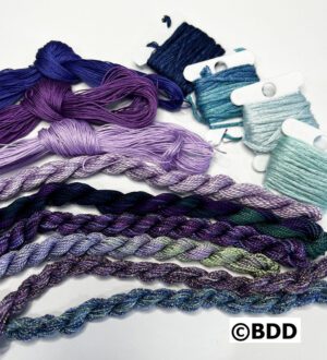 A group of different colored yarn and thread.