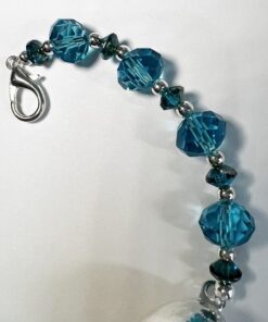 A blue bracelet with silver accents and a lobster clasp.