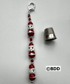A close up of a key chain with a thimble