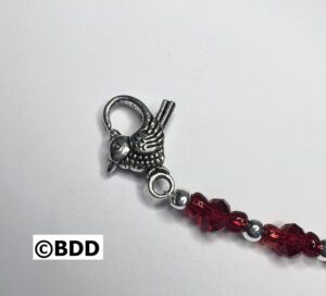 A clasp is attached to the end of a beaded bracelet.