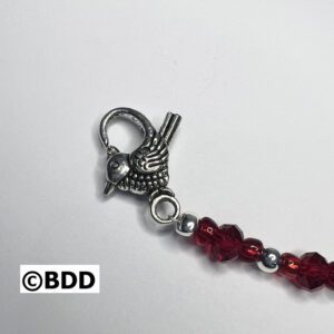 A clasp is attached to the end of a beaded bracelet.