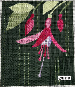 Pink flower needlepoint on dark green background.