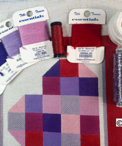 Needlepoint canvas with colorful threads and spools